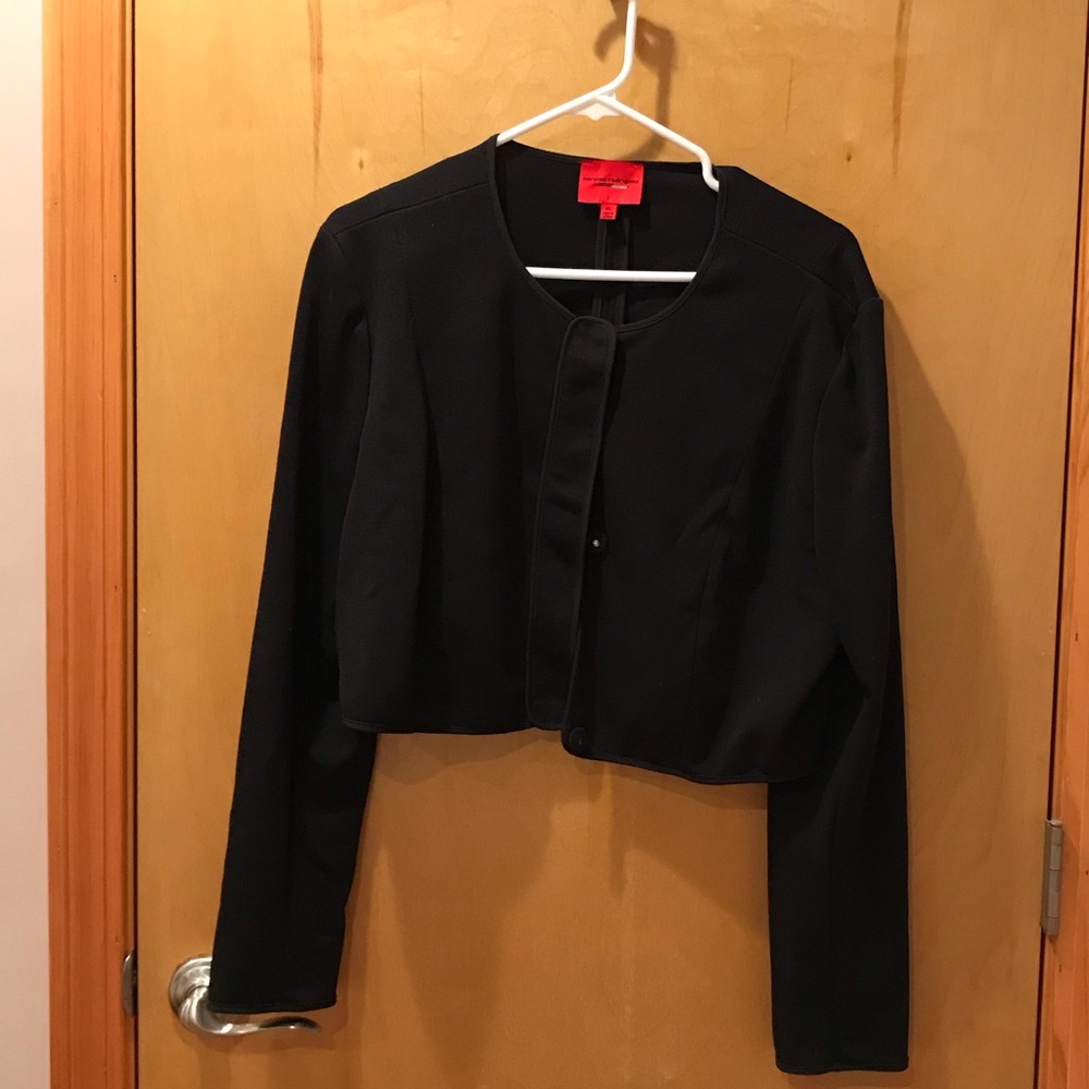 Black cropped jacket with snap closures.